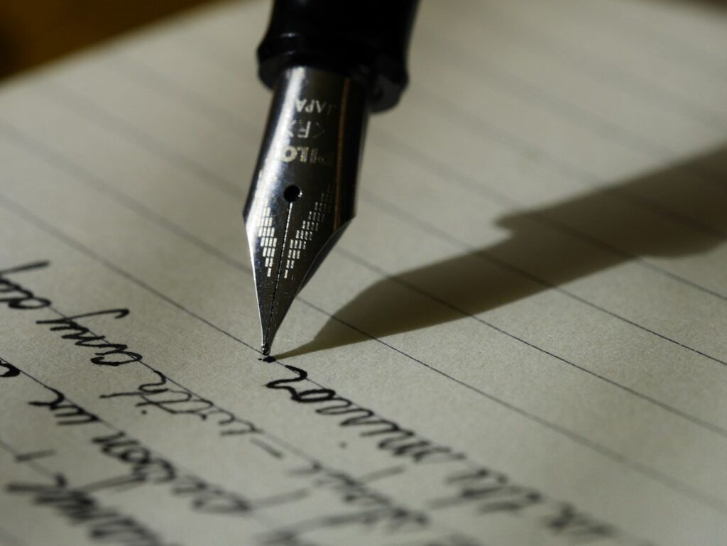 Notebook and pen on a desk representing a practical book publishing budget