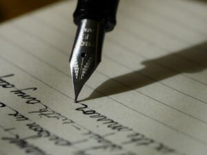Notebook and pen on a desk representing a practical book publishing budget
